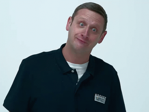 Tim Robinson tilts his head, one eyebrow up, skeptical smirk mid-‘You sure about that?’ — the reaction meme behind every 2 a.m. confirmation prompt.